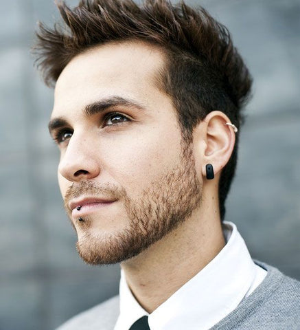 Stylish man showcasing his helix piercing.