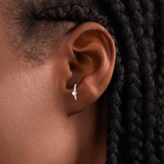 Woman with sterling silver anti-tragus piercing.