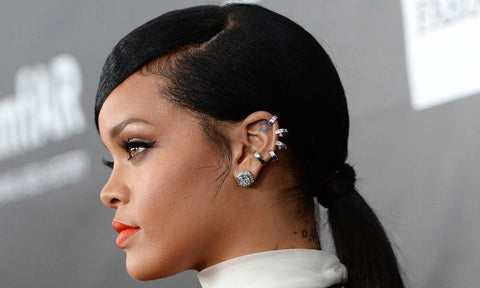 Rihanna with a helix piercing and others on her ear.