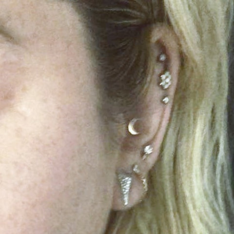 Kesha's left ear with her helix piercing and others.
