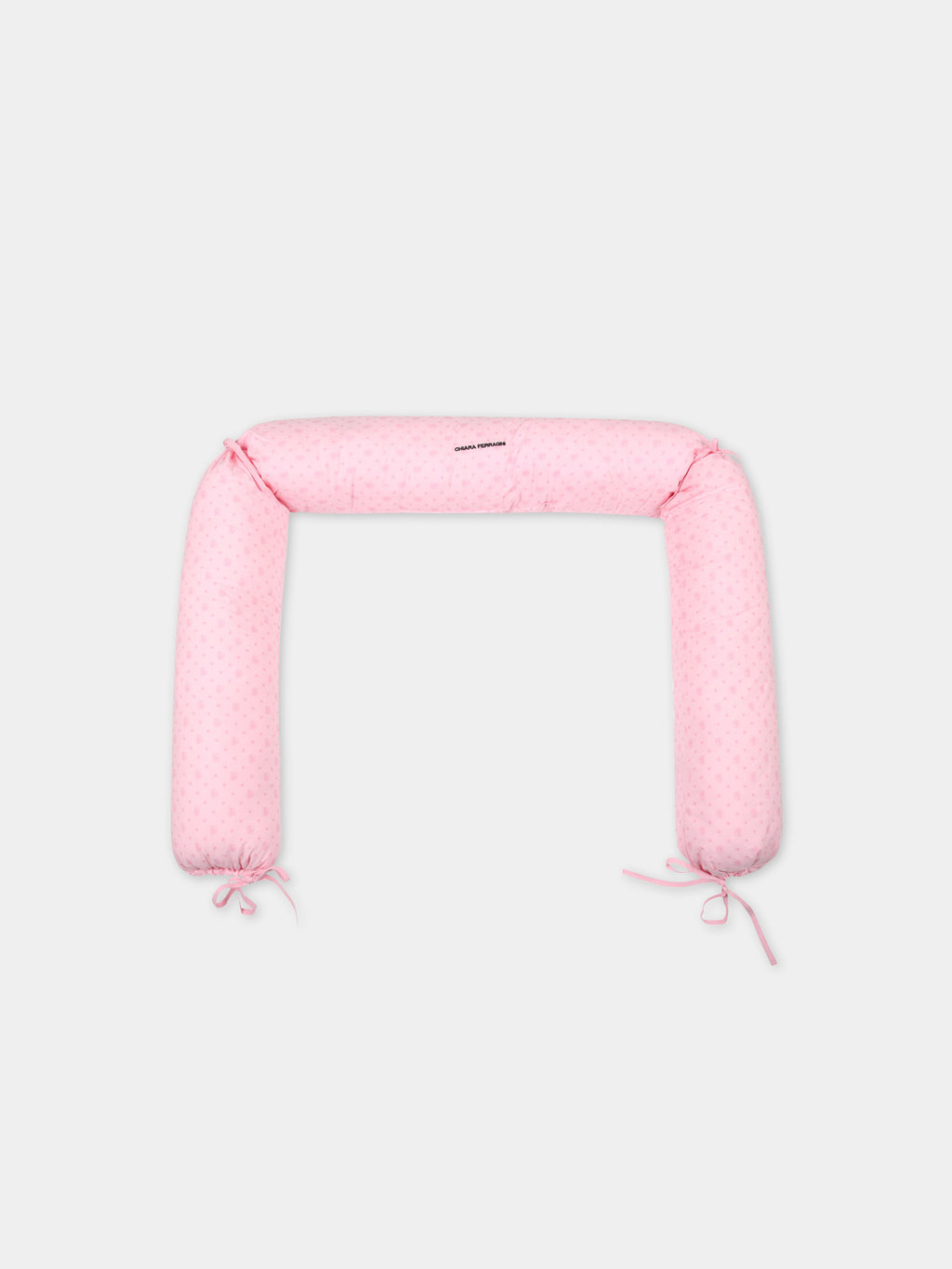 Pink crib-reducer for baby girl with iconic winking eye