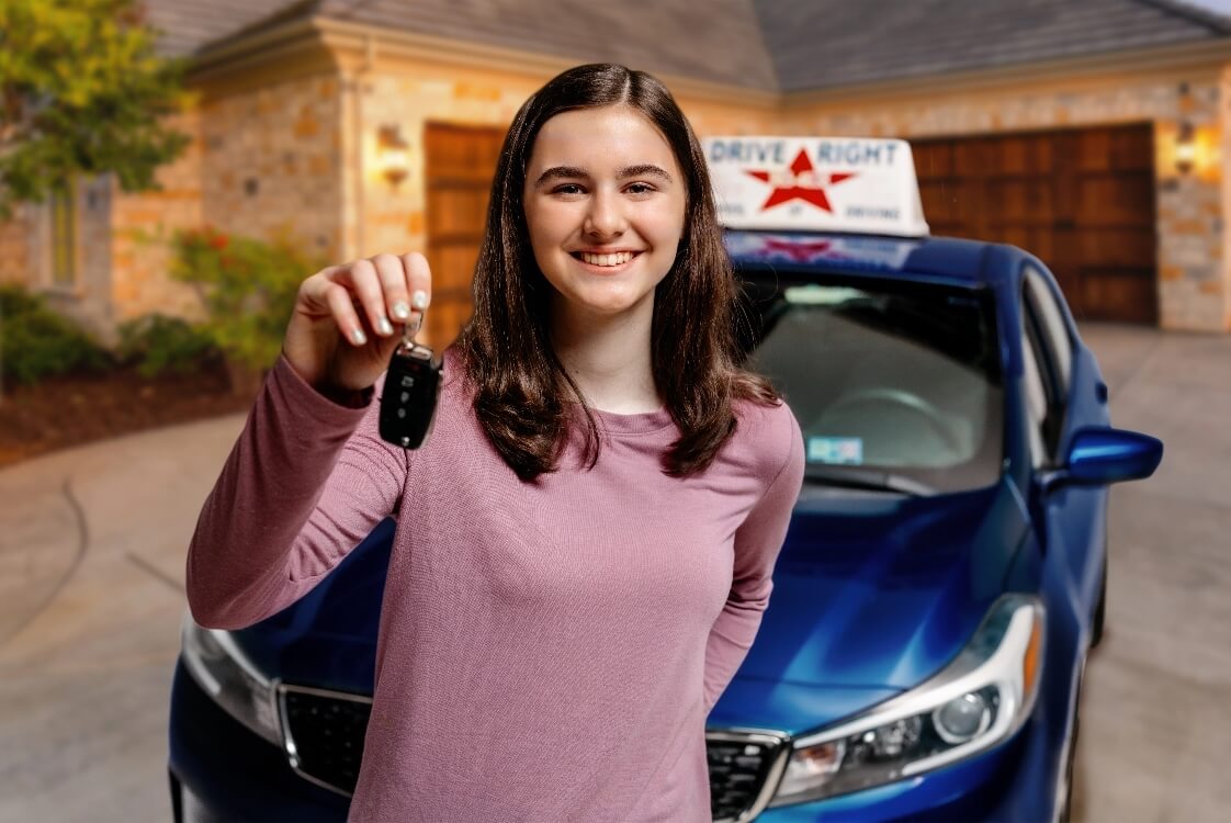 Teenage girl smiling with Driver's License.