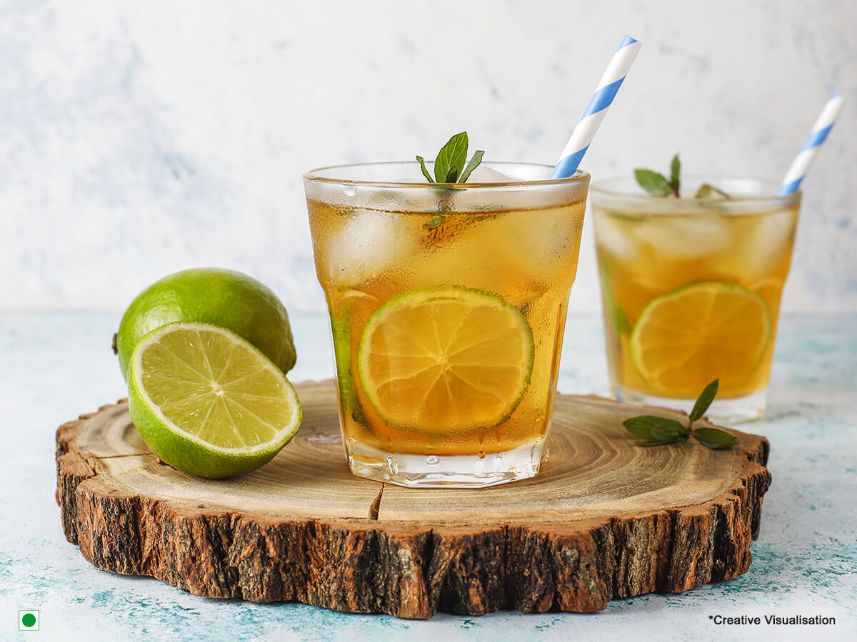 Lemon ice tea in a glass with slices of lemon & mint to garnish!  Caption: Squeeze the day with a delicious glass of homemade lemon iced tea!