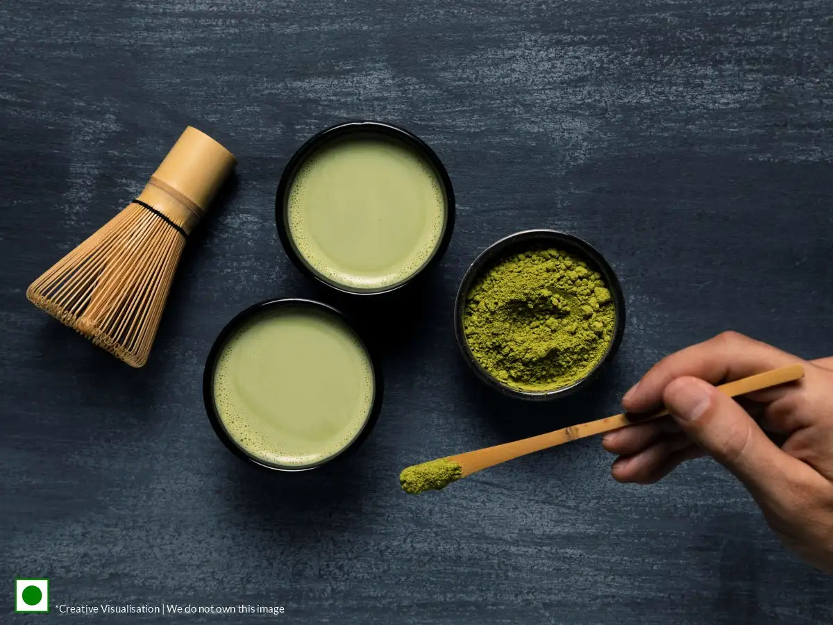 An image of matcha tea cups along with matcha powder kept on the side.