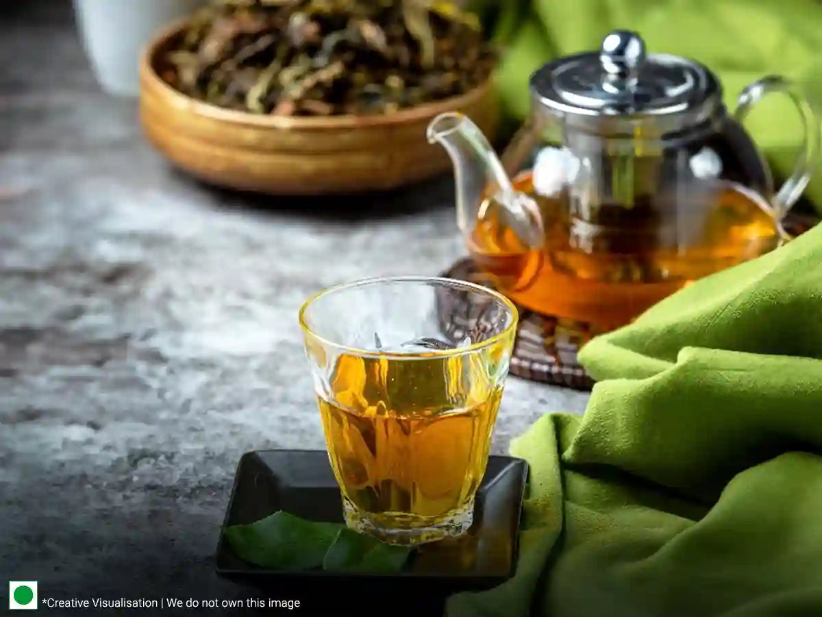 A cup of green tea placed on a green cloth, the perfect drink for a refreshing moment