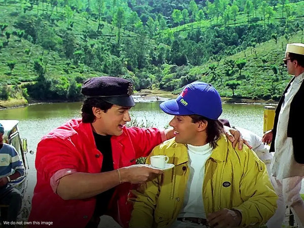 Amir Khan offering a cup of tea to Salman Khan in a movie.