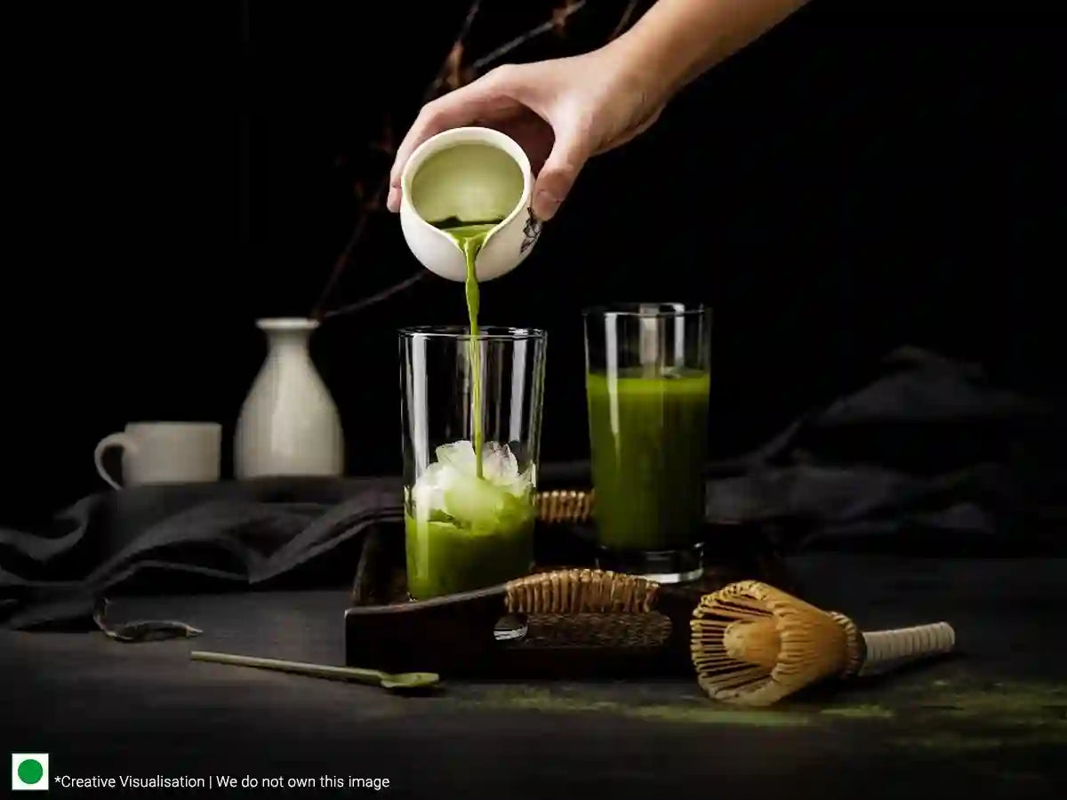A person pouring green tea into a glass, creating a refreshing beverage for tea-infused cocktails and mocktails.