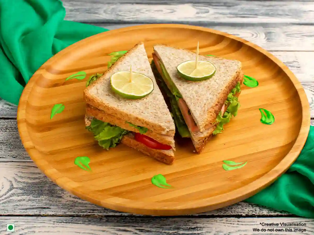 An image of a vegetable sandwich put on a wooden plate and held together with toothpicks.