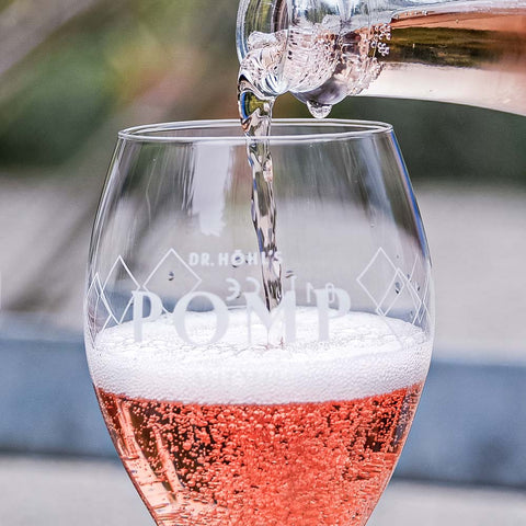 close up of poured glass of POMP Rosé sparkling wine
