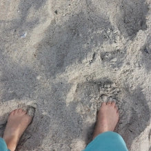 Sandy's feet in the sand