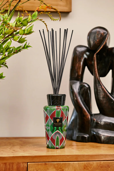 Baobab Maxi Wax Malia Diffuser on a side board with an african art sculpture styled and set on burl finish side board