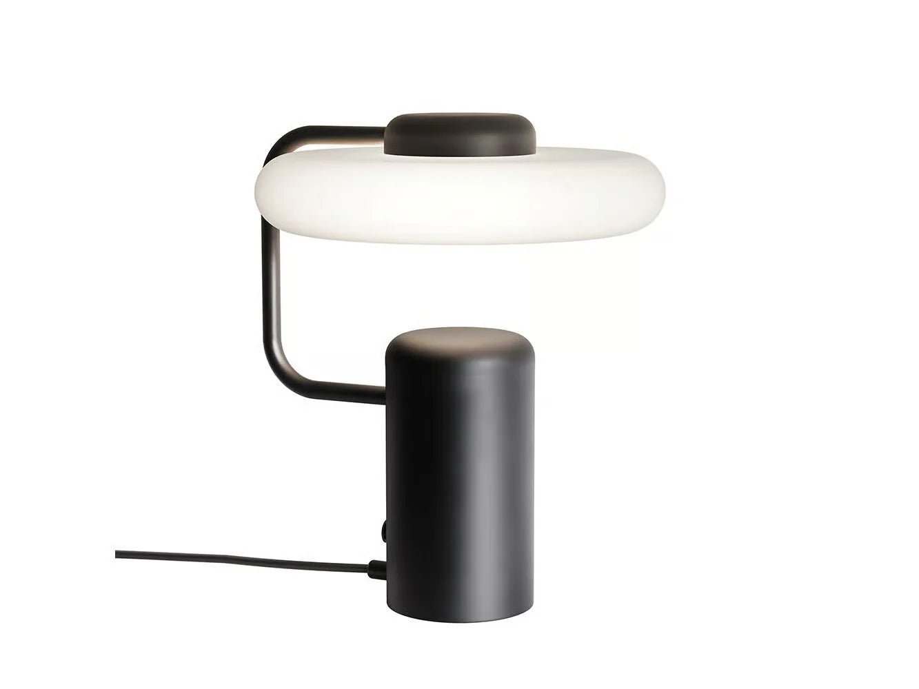 Contemporary designer table lamp with a circular frosted glass shade and black cylindrical base, perfect for modern minimalist bedrooms, available at Spacio.