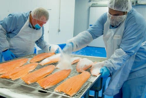 Workers preparing smoked salmon