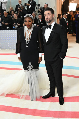 Serena Williams and Alexis Ohanian both wear Gucci. The tennis superstar also wore jewelry by Tiffany & Co. and a headband by Lenet New York.