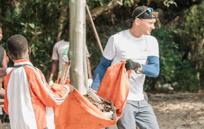 Alt: A group of men carrying out a Mayekoo beach clean up in Africa.