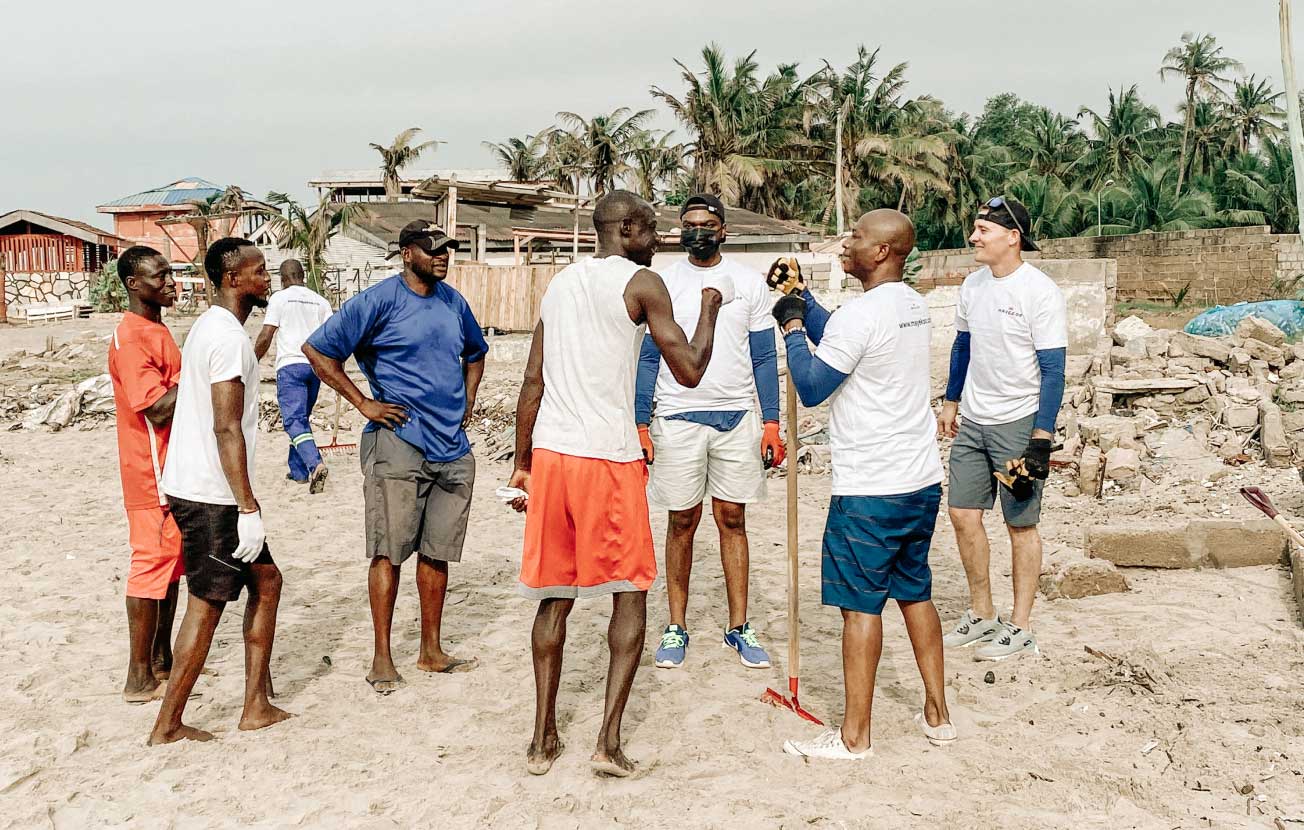 Alt: A group of men carrying out a Mayekoo beach clean up in Africa.