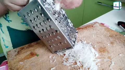 Grate the Mooli using a grater.