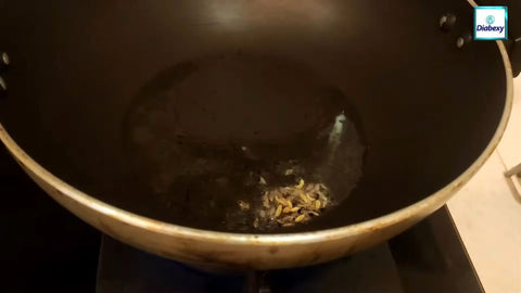 In a kadai (pan), heat some olive oil.