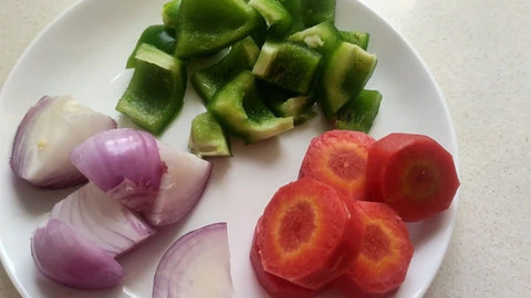 Chop vegetables: 50g of capsicum, 50g of carrot, and 50g of onion.