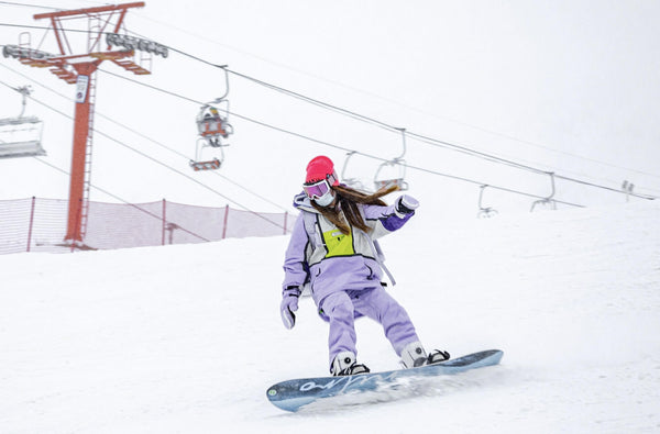 a woman is snowboarding