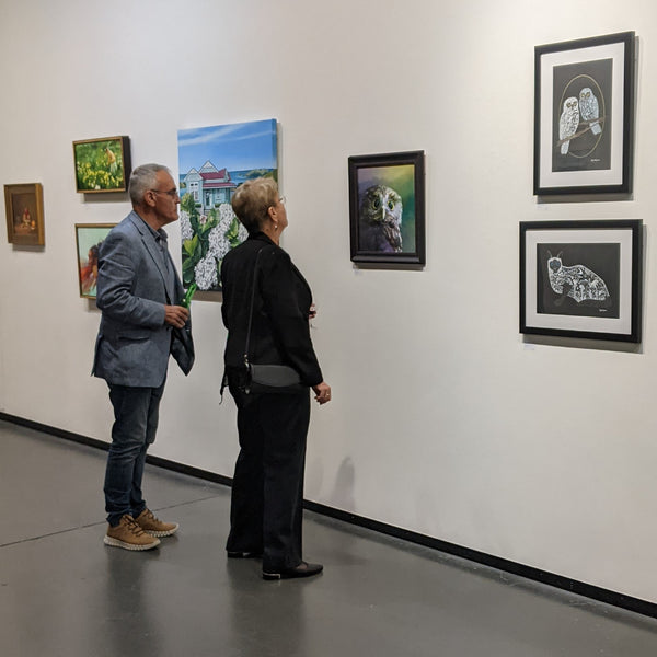 Two visitors view my ruru painting