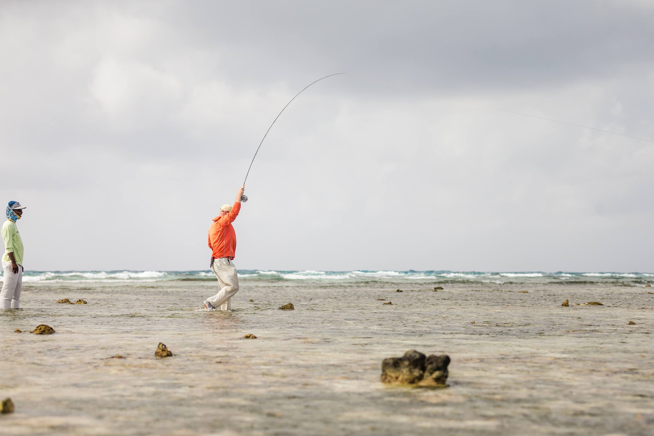 Fishing Rod In Sand Of Tropical Beach Stock Photo - Download Image