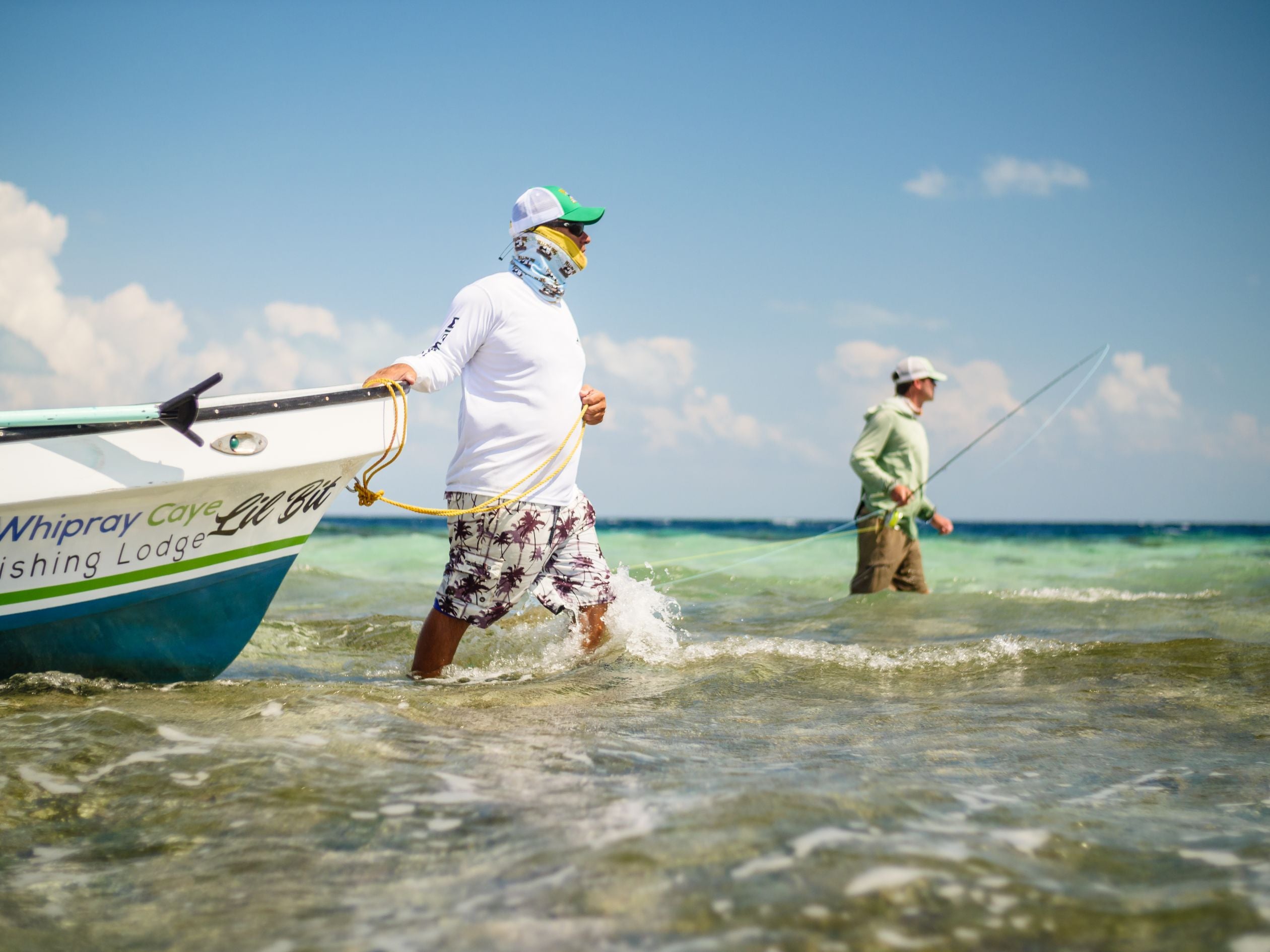 Fly fishing rod and jack fish on beach in Belize Central America