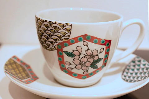 Kutani ware cup and saucer decorated with tortoiseshell crests
