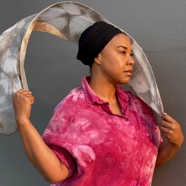 Model wearing a fuchsia smock and shibori scarf