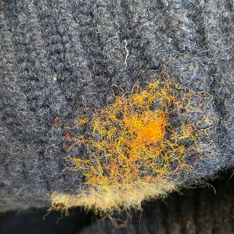 Underside of patch showing hole in sweater