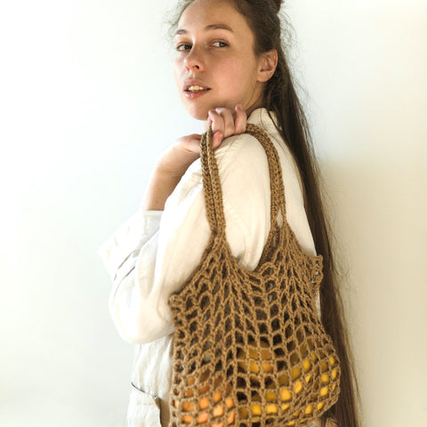 Cotton string bag held by woman shopper