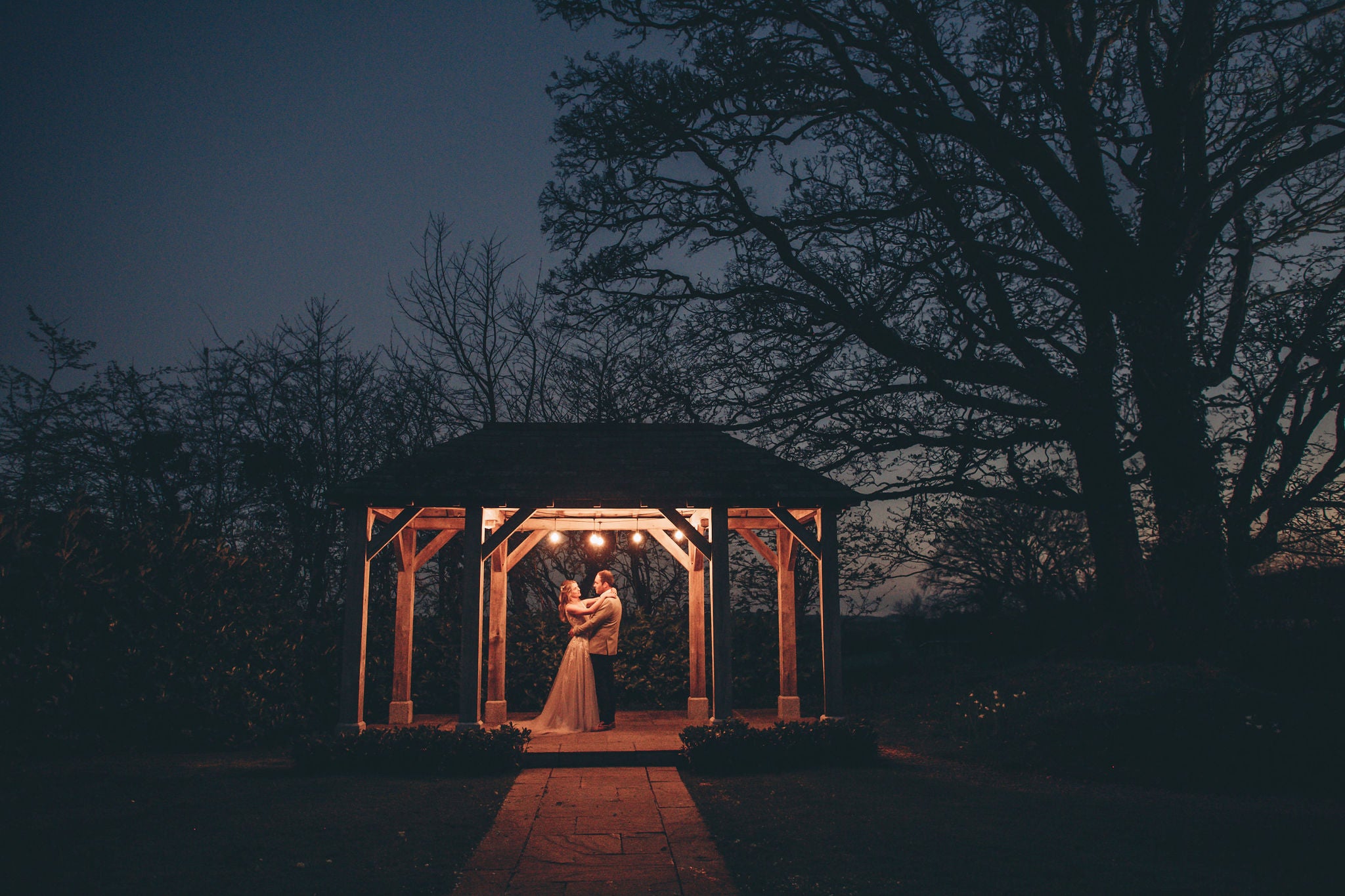 Couple under arbour in evening at Trevenna barns