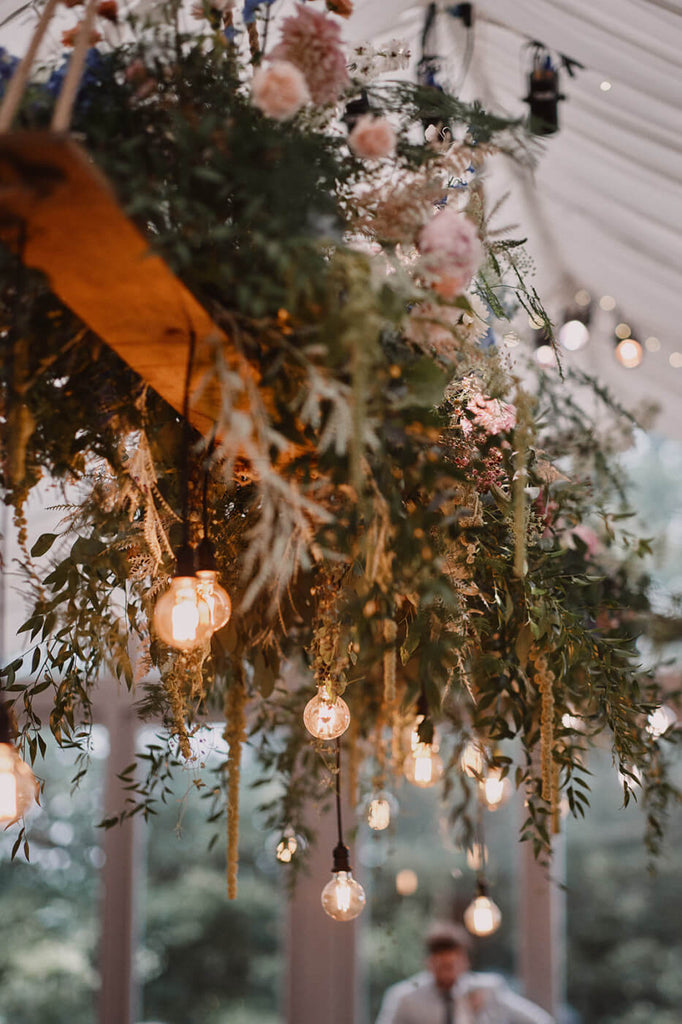 Hanging oak plank, with floral and lighting install wedding