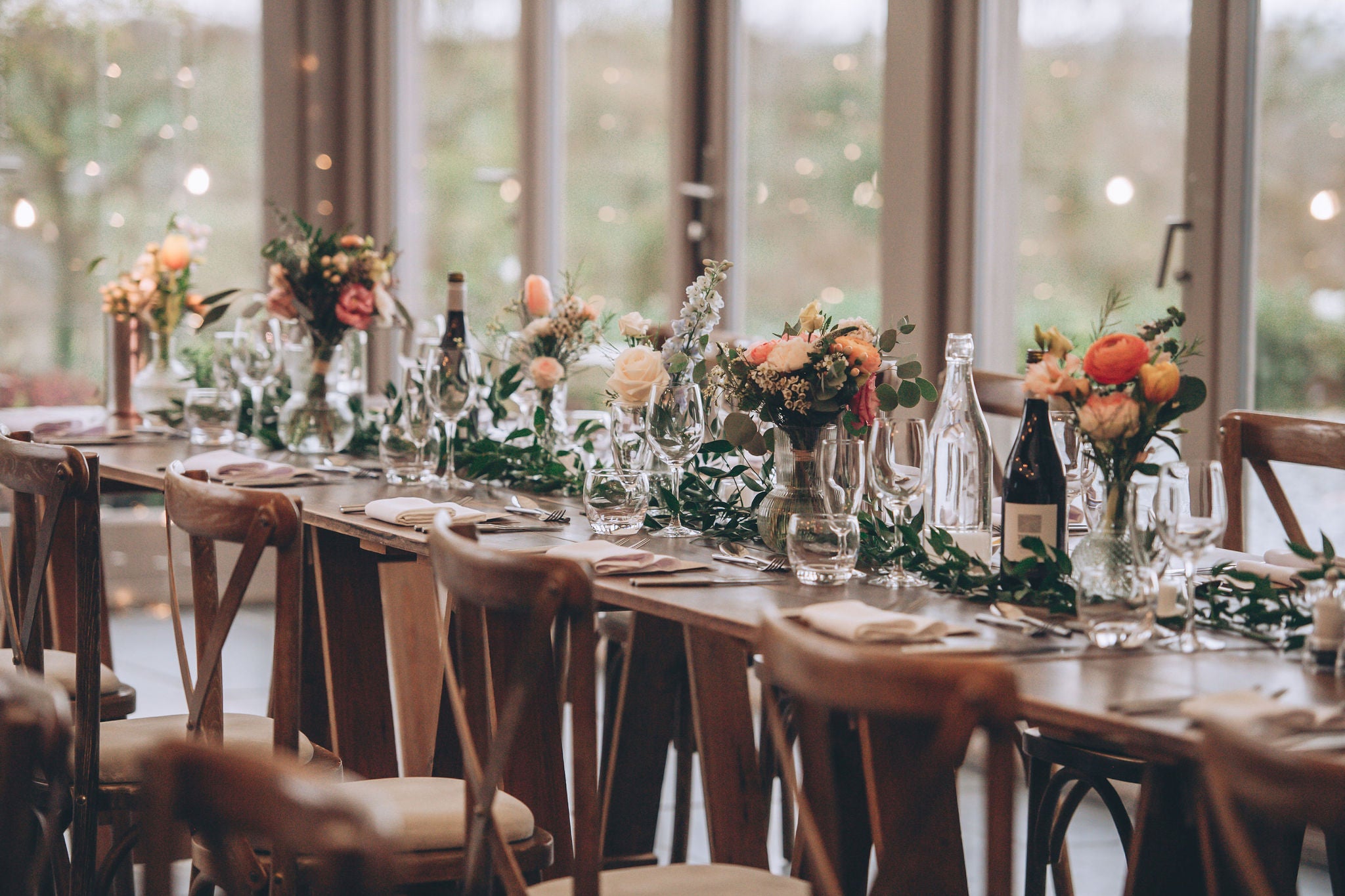 Flower vases on wedding food tables at Trevenna barns