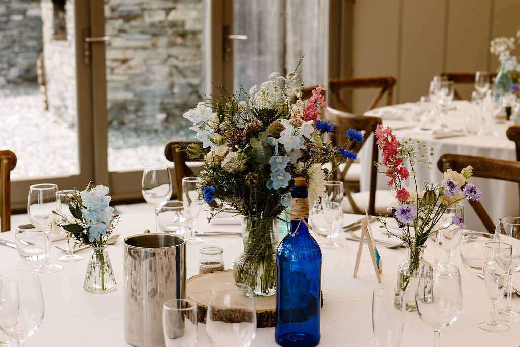 Table wedding flowers on round table at Trevenna barns