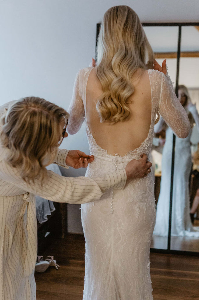 bride putting on the dress