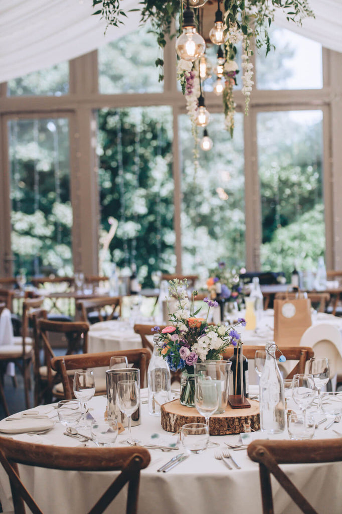 oak chairs with summer flowers Trevenna wedding