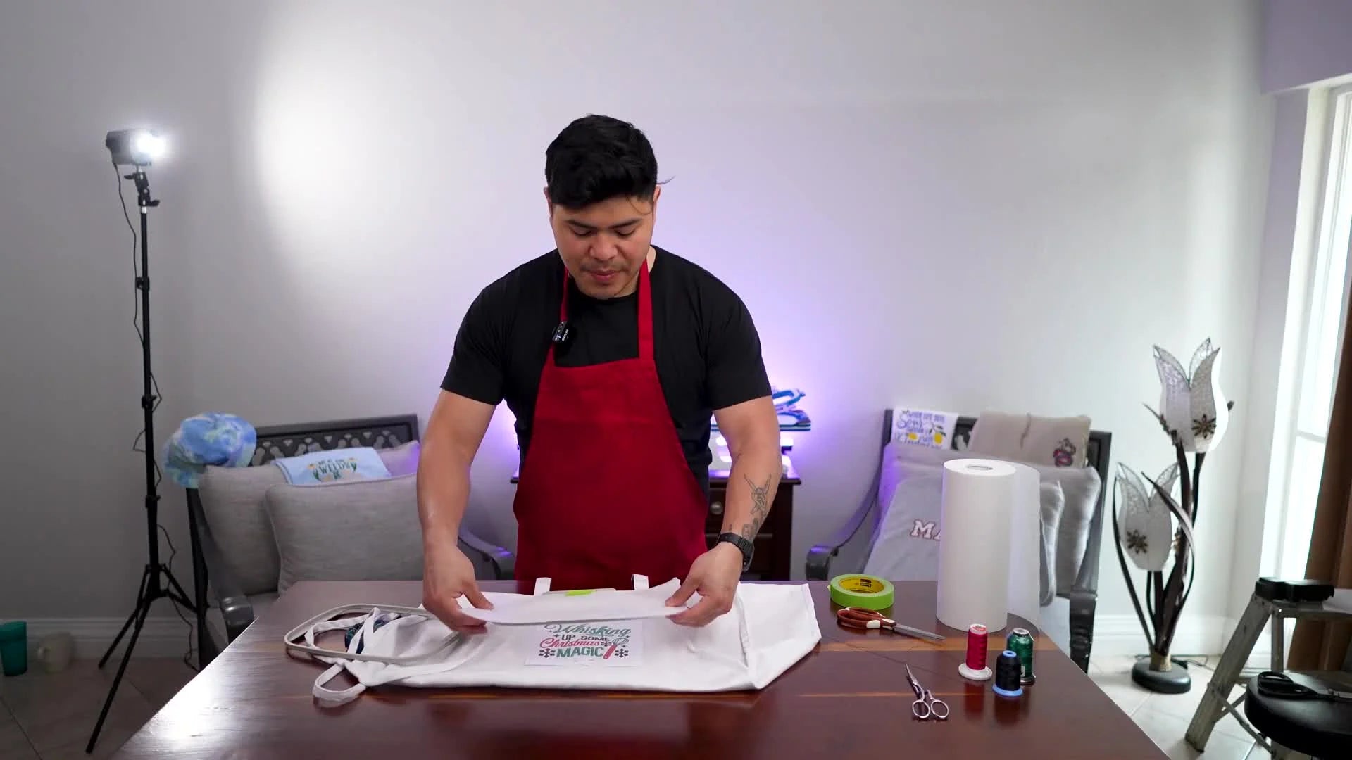 Applying painter's tape to hold the tearaway stabilizer onto the inner embroidery hoop.