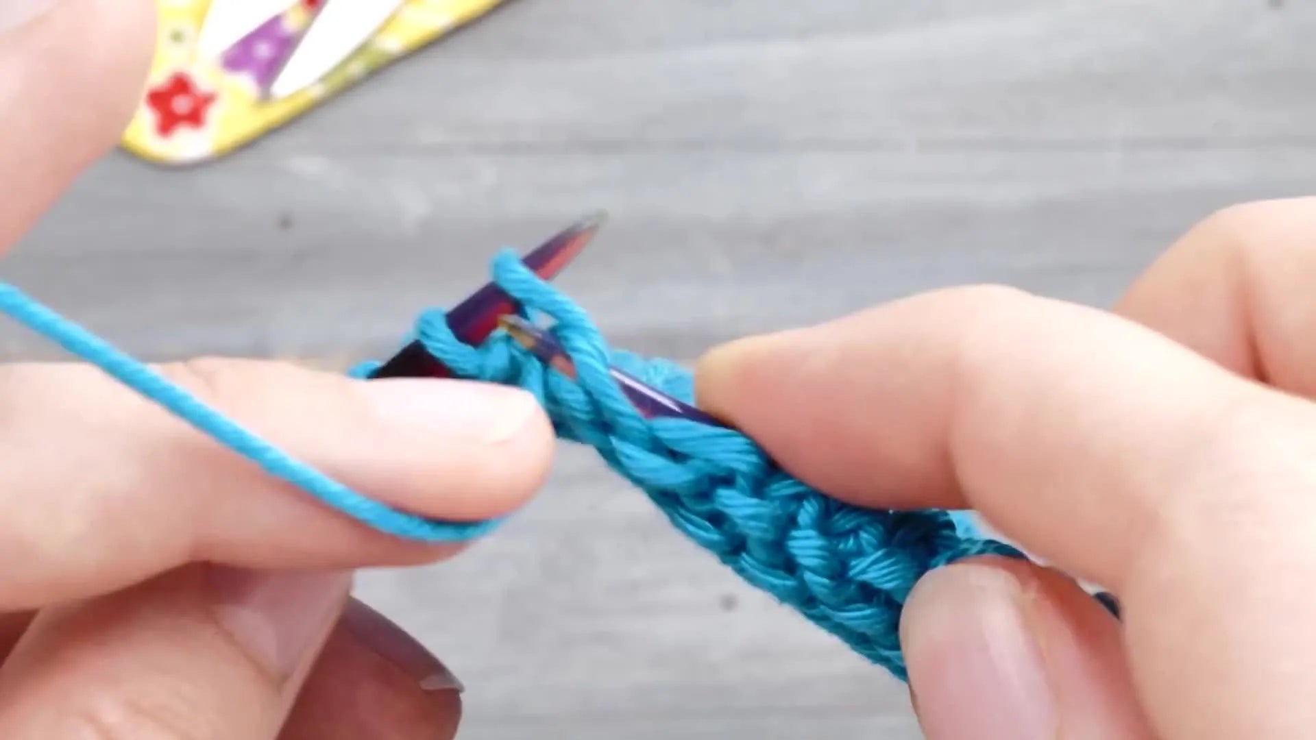 Close-up of purl stitches showing consistent tension without noticeable slack at the edge.