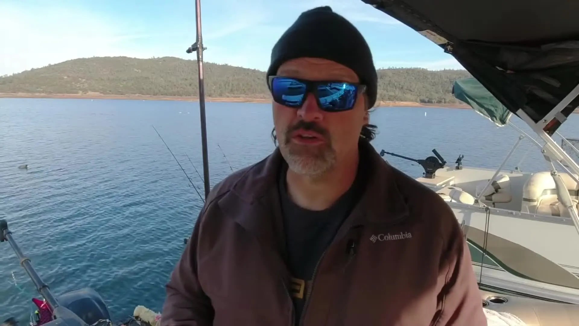 Cal Kellogg holds up a white worm threader for the camera.