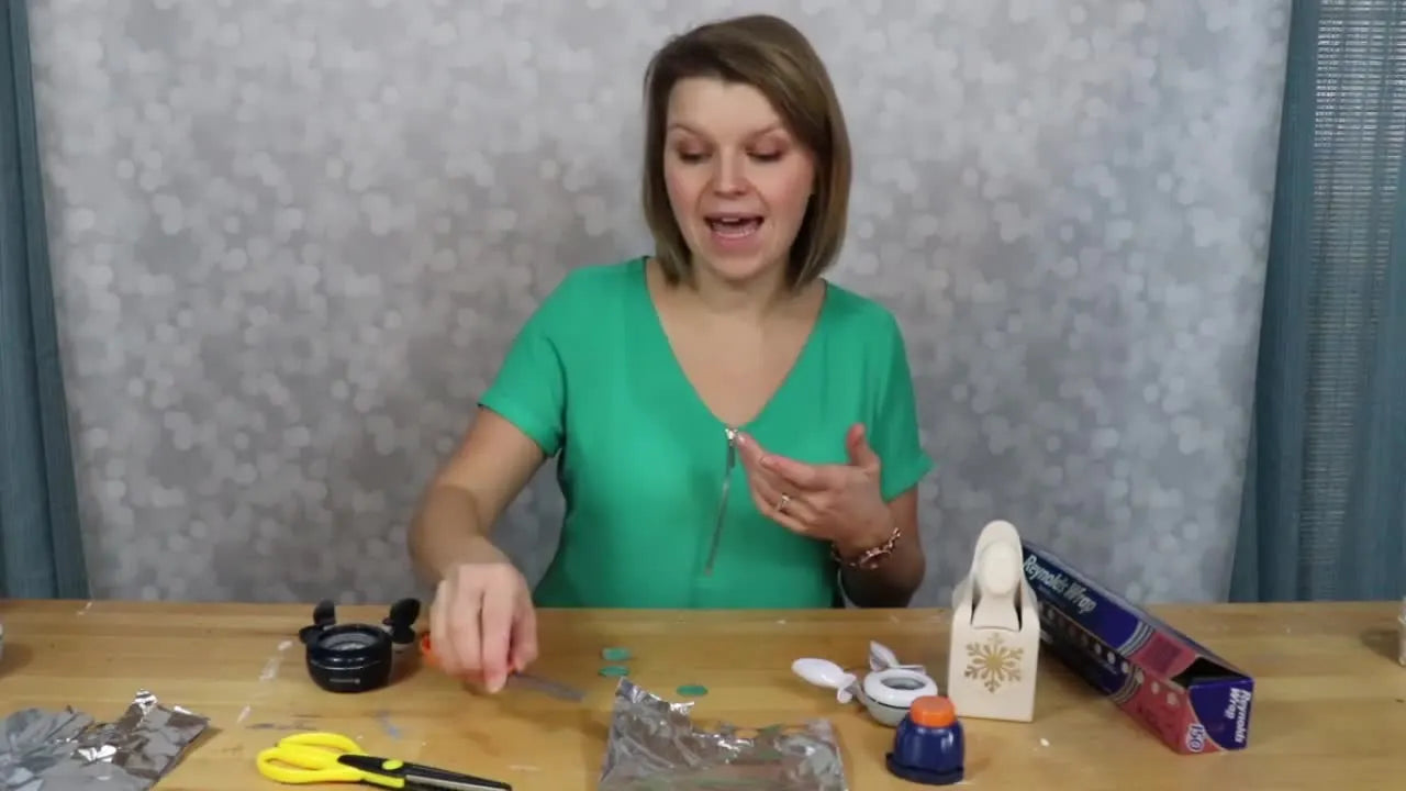 Presenter holding a pair of orange-handled Fiskars scissors while explaining tool care.