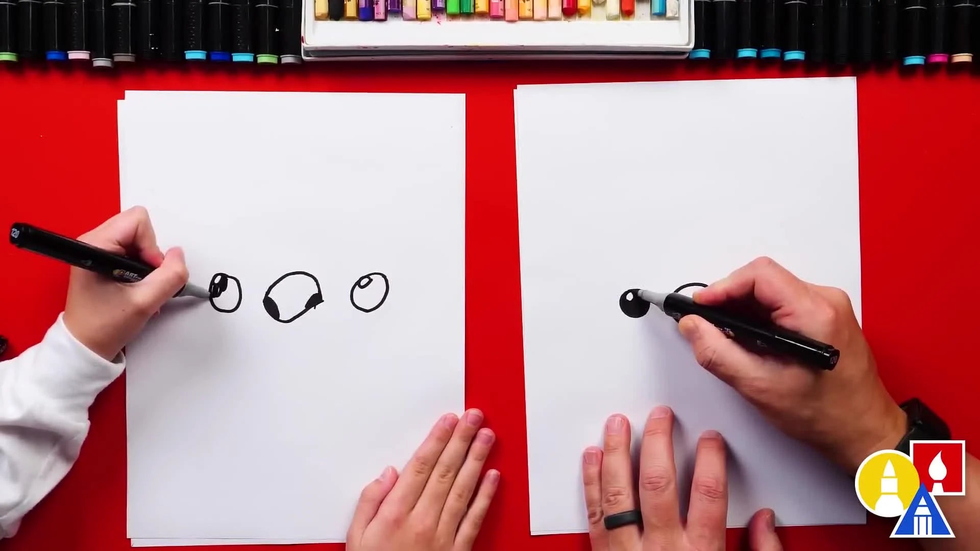 Hands coloring in the large circle of the eye, leaving a small white highlight.