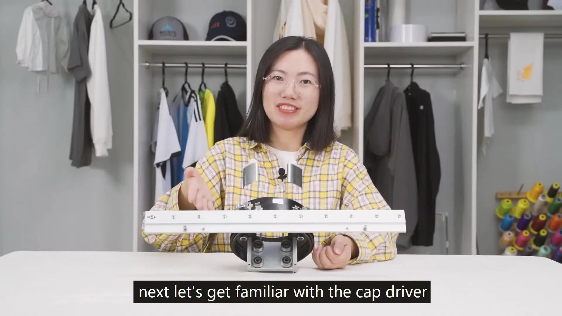 Hands holding the cap driver, showing its long guide rail and four holes.