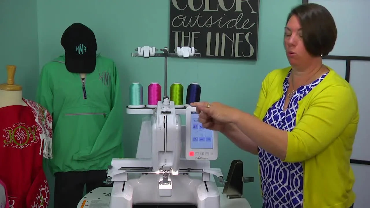 Blue thread being guided up and through the metal take-up lever.