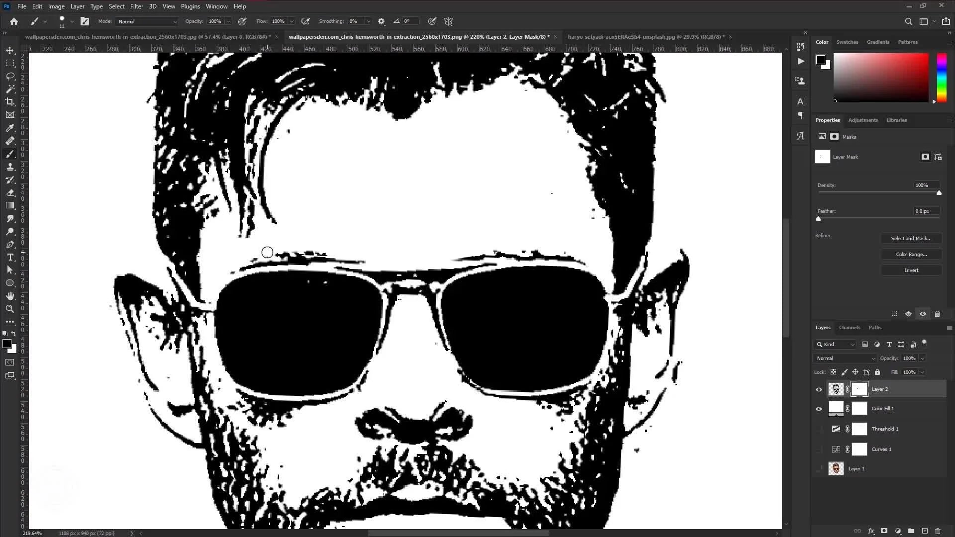 Using the brush tool on a layer mask to clean up the vector face.