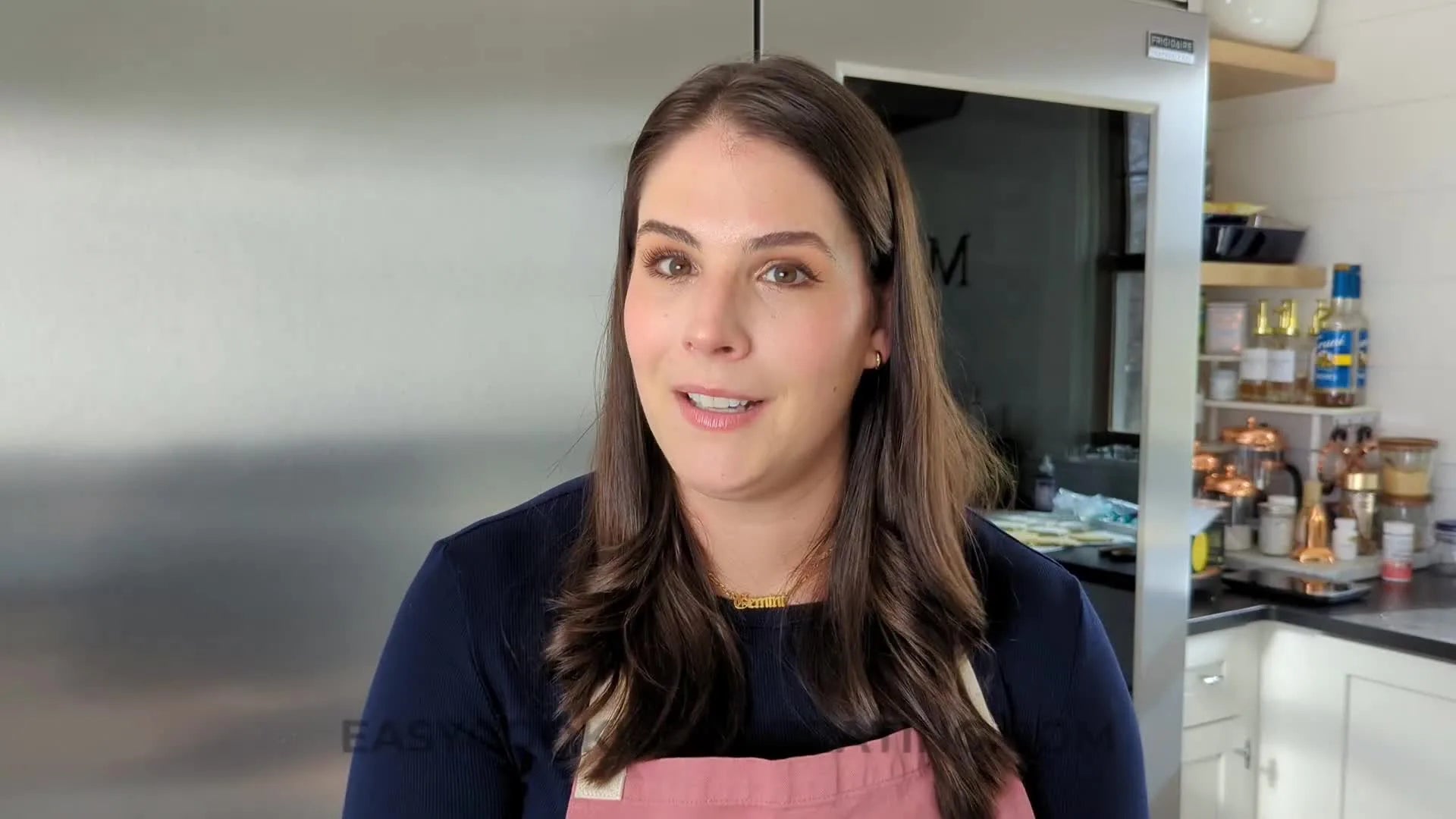 A hand demonstrates making contact, lifting the bag slightly, and pulling the icing to form a clean line, showing the correct technique for piping letters.