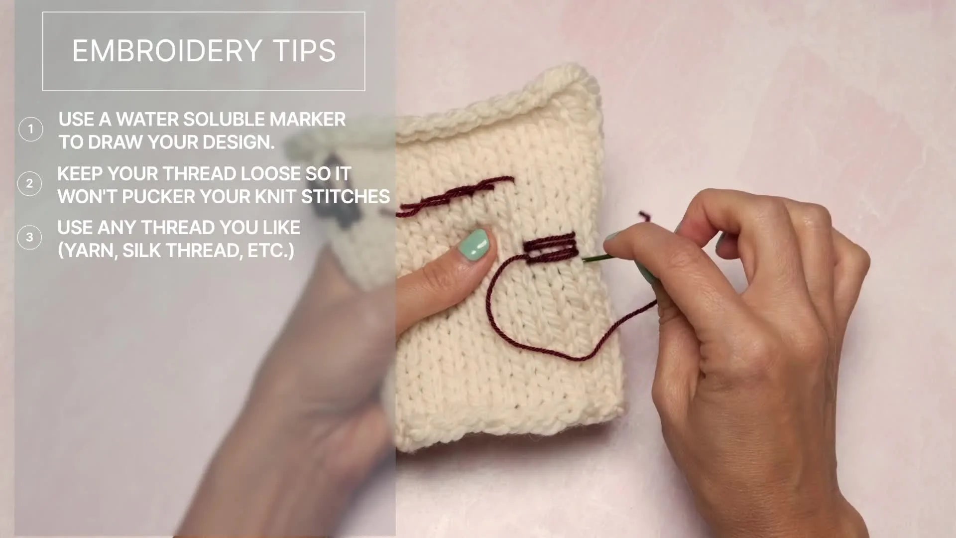 Close-up of hands holding a skein of Cash Silk Sock yarn, showing the material used for embroidery in the tutorial.