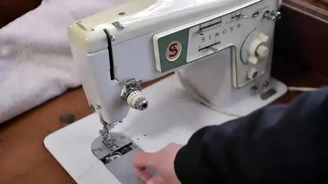 The bobbin area of a Singer Stylist, showing a standard top-loading system without the wind-in-place button.