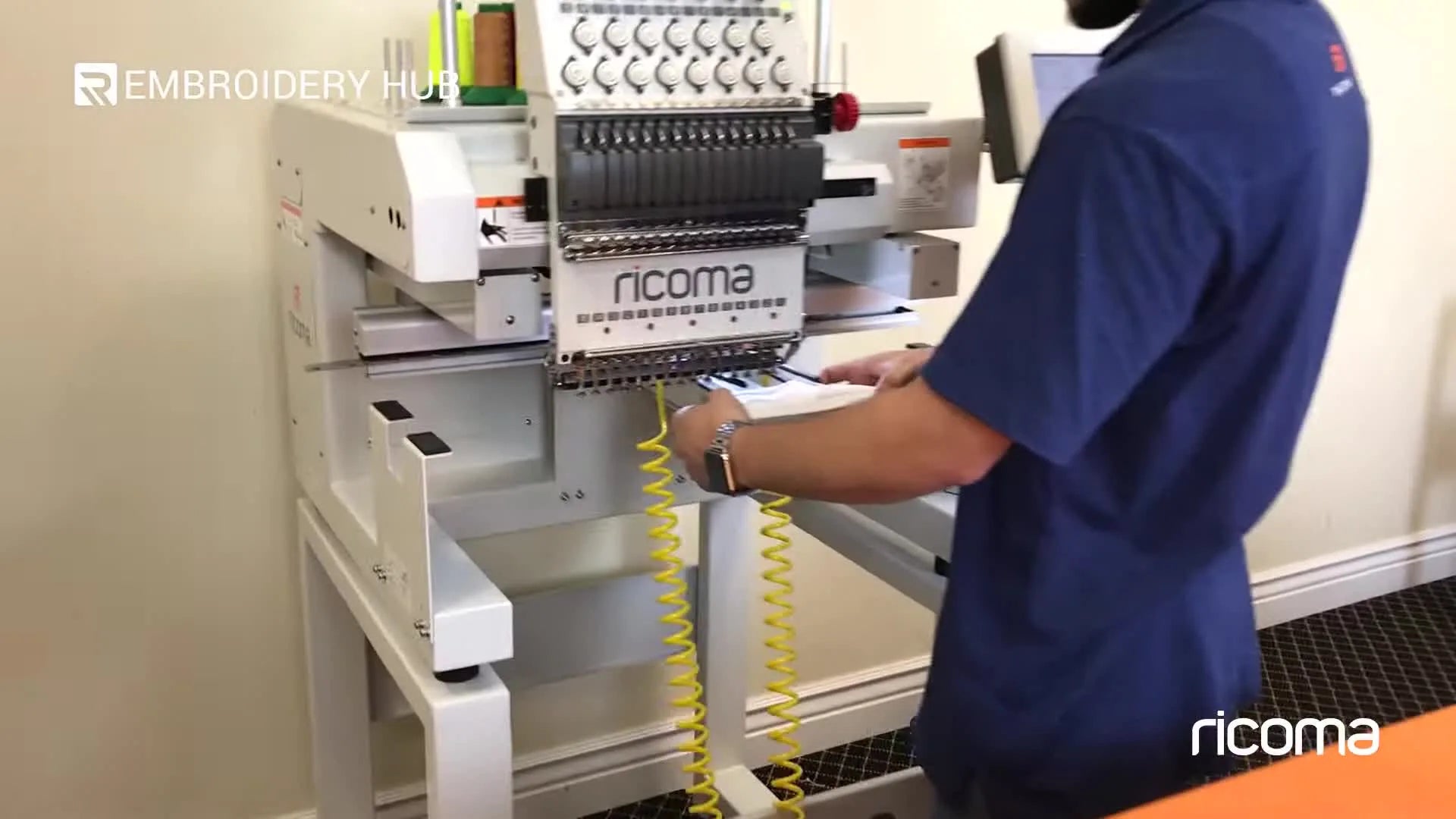 Inserting a shoe into the robot embroidery frame.