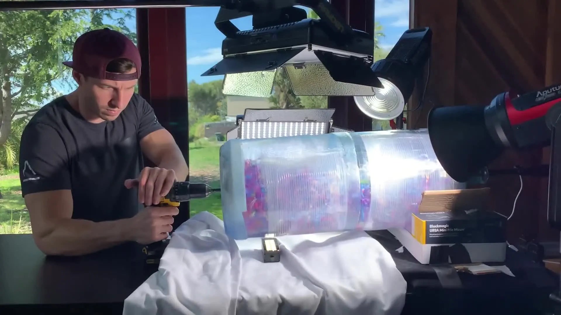 Power drill spinning the water jug containing popcorn.